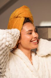 Soft, absorbent hair towel in a variety of colors including mint green, black, pink, dark green, and mustard yellow.