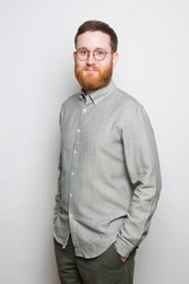 A gray button-down shirt with a classic, casual style. Made of a soft, breathable material, it features a collared neckline and long sleeves.