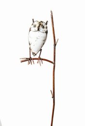  A white metal owl sculpture mounted on a wooden stick, designed as a decorative bird feeder.
