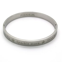 A silver-colored cuff bracelet with the text "Pinkiez" and "Sparkle more" engraved on it.

The product is a silver-colored cuff bracelet from the Pinkiez jewelry brand. The bracelet features the text "Pinkiez" and "Sparkle more" engraved on the surface. The bracelet has a simple, minimalist design that would complement a variety of casual or dressy outfits.
