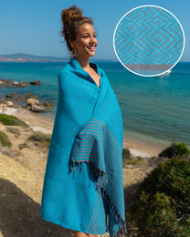 Turquoise and gray striped beach towel made of soft, absorbent Turkish cotton.