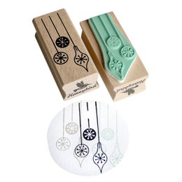 Festive rubber stamp set with ornament designs for holiday crafting. Includes various shapes like circles, flowers, and abstract patterns in green and brown colors.
