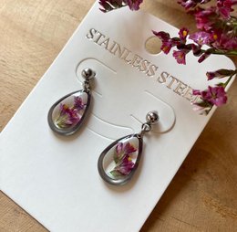 Silver stainless steel drop earrings with real pink statice flowers encased in resin.