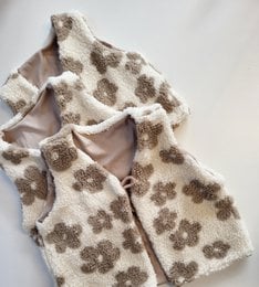 Ecru floral waistcoat, a kids' cardigan with a soft, fuzzy texture and a floral pattern in shades of brown and beige. The waistcoat features a button closure and is available in sizes 74/80 to 122/128.