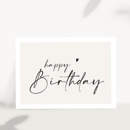  A handwritten "Happy Birthday" greeting card with a green leaf wreath and white plates on a light background.