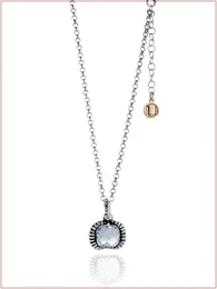  Elegant fantasy necklace with a round pendant featuring a purple gemstone and gold accents. Crafted with a silver-tone chain and a small gold-tone charm.
