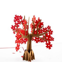 A red pop-up card featuring a tree with vibrant red leaves. The card is made of sturdy cardboard and has a 3D design that creates a striking visual effect.