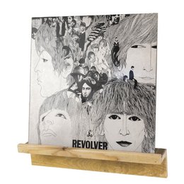 A black and white album cover featuring a close-up portrait of a young man with shaggy hair and a serious expression. The title "U2 WAR" is prominently displayed in red text.