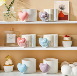  Heart-shaped ceramic mug with pastel-colored heart and floral designs.