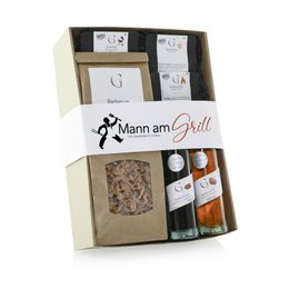 This gift set includes a variety of spice mixes and seasonings for grilling, including a rub, marinade, and spice blend. The set comes in a wooden crate with the "Mann am Grill" (Man at the Grill) branding.