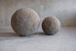 Large and small white yoga balls made of soft, plush material for comfortable exercise.