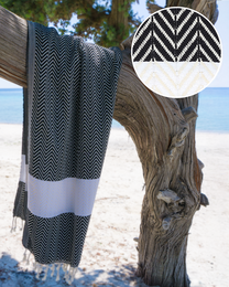 Black and white striped Turkish hammam towel with tassels, suitable for beach, spa, or sauna use.