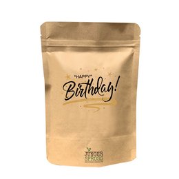A round, tall candle with the text "Happy Birthday (Basil)" printed on the packaging. The candle is made of natural materials and is suitable for use in a garden or outdoor setting.