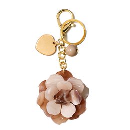  Resin dog keychain in coral pink, coffee, grey, red, green, and blue colors, with and without boxes. The keychain features a plush dog charm with a gold-tone metal ring.