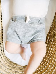 Grey and pink baby bloomers with a soft, textured pattern. Suitable for newborns to 18 months.
