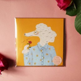 Greeting card with a poodle illustration, featuring a poodle wearing a blue shirt and holding a flower. The card has an eco-friendly design.