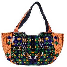 Handmade antique Genoa tote bag with vibrant orange, purple, and green geometric patterns and floral designs.