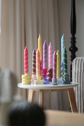  Colorful, striped candles in various pastel shades including pink, yellow, and red. The candles appear to be part of a "Twister Collection" and are suitable for use as dinner candles.