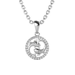 Silver-toned pendant with a circular design featuring a crystal-embellished scorpion symbol, suspended from a silver chain.