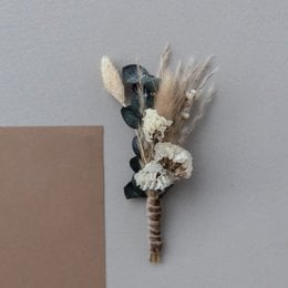 Elegant bohemian-style brooch with dried eucalyptus, pampas grass, and neutral-toned flowers.