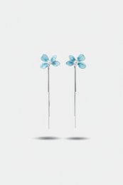 Blue enamel flower drop earrings with silver tassels, delicate floral design, long dangle style.