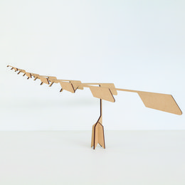 A meditative puzzle mobile made of light brown wood with a balanced, geometric design. The mobile features various wooden shapes and pieces that can be arranged in different configurations to create a calming, contemplative display.