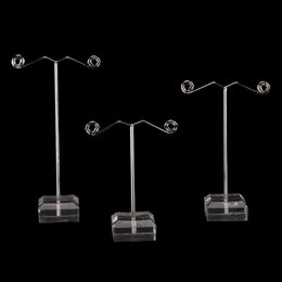  A set of 3 clear acrylic earring stands with multiple hooks for displaying and organizing earrings. The stands have a simple, minimalist design and are suitable for a variety of earring types.