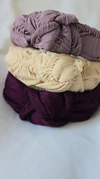 Knot wave hard headband in oatmeal and mauve colors, made of soft, textured fabric for kids.