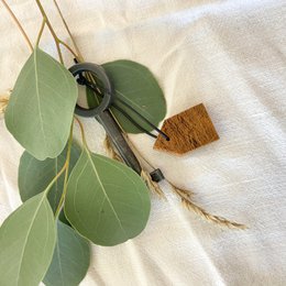Wooden key chain with leaf accents.