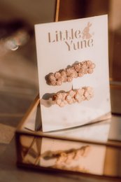  Set of 5 decorative hair clips in neutral colors and floral designs. Includes clips with beige, brown, and multicolored accents.