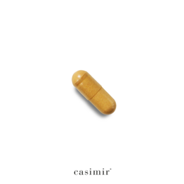 Vitamin C supplement in a brown bottle labeled "THE DOORMAN | VITAMIN C" by Casimir. The supplement is a yellow capsule-shaped pill.