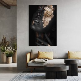 Striking abstract portrait of a woman with gold and black face paint, conveying a sense of mystery and artistic expression.