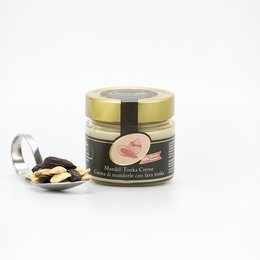 Almond Tonka Crème, a chocolate spread made with almonds and tonka beans, in a glass jar with a gold lid.