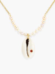 Elegant necklace with coral and cowrie shell pendant, accented with pearls. Stylish accessory for any occasion.