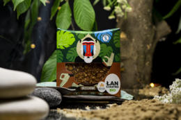 A round, tall cookie with peanut butter filling, packaged in a colorful, tropical-themed wrapper featuring a cartoon character.