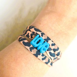  Leopard print wrap bracelet with the word "love" in blue letters.