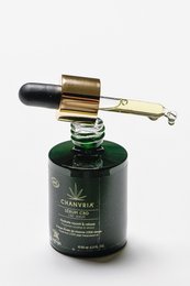 Green glass bottle with gold dropper cap containing organic hemp CBD serum. Bottle has "CHANVRIA - HEMP CBD SERUM BIO 30 ML" label.