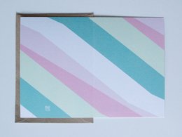 Colorful abstract greeting card with pastel stripes in shades of blue, pink, and white.