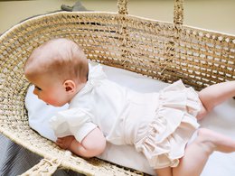 Light beige bloomers with ruffles for baby girls, available in sizes newborn to 24 months.