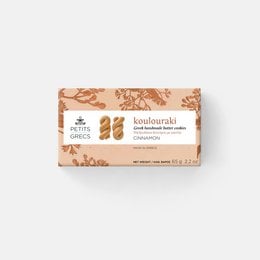 Handmade Greek butter cookies with cinnamon, round and golden in color, packaged in a box with floral designs.