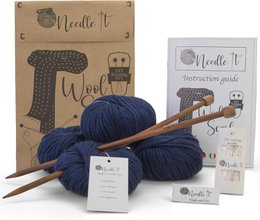 Navy blue knitting kit with needles and wool for a scarf. Includes all necessary materials for a beginner to learn knitting.