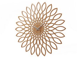 A large, decorative wall clock with a sunflower-inspired design in a golden color. The clock features an intricate, layered pattern of overlapping petals or leaves that create a striking, radial design.