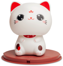  A white ceramic figurine of a lucky cat with large eyes, red ears, and a red collar. The cat is sitting on a red platform.