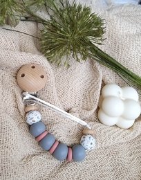 Newborn pacifier clip with a galaxy design, featuring a soft, plush pacifier clip in shades of blue and gray.