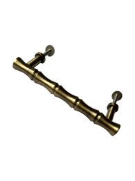  Bamboo brass door knob with a cylindrical shape and textured surface.