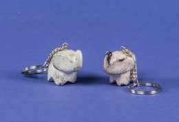 Silver-colored soapstone elephant keychains with intricate details.