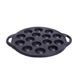 Cast iron poffertjes pan with 12 round indentations for baking small Dutch pancakes.