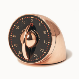 Copper-colored kitchen timer with analog dial and rotating indicator. Designed for easy time tracking in the kitchen.