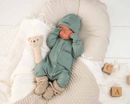  Cozy sand-colored ribbed jersey baby suit with a soft, plush texture and a comfortable hooded design.