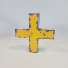 Colorful recycled metal cross magnets in various sizes and colors, including yellow, blue, and metallic finishes.